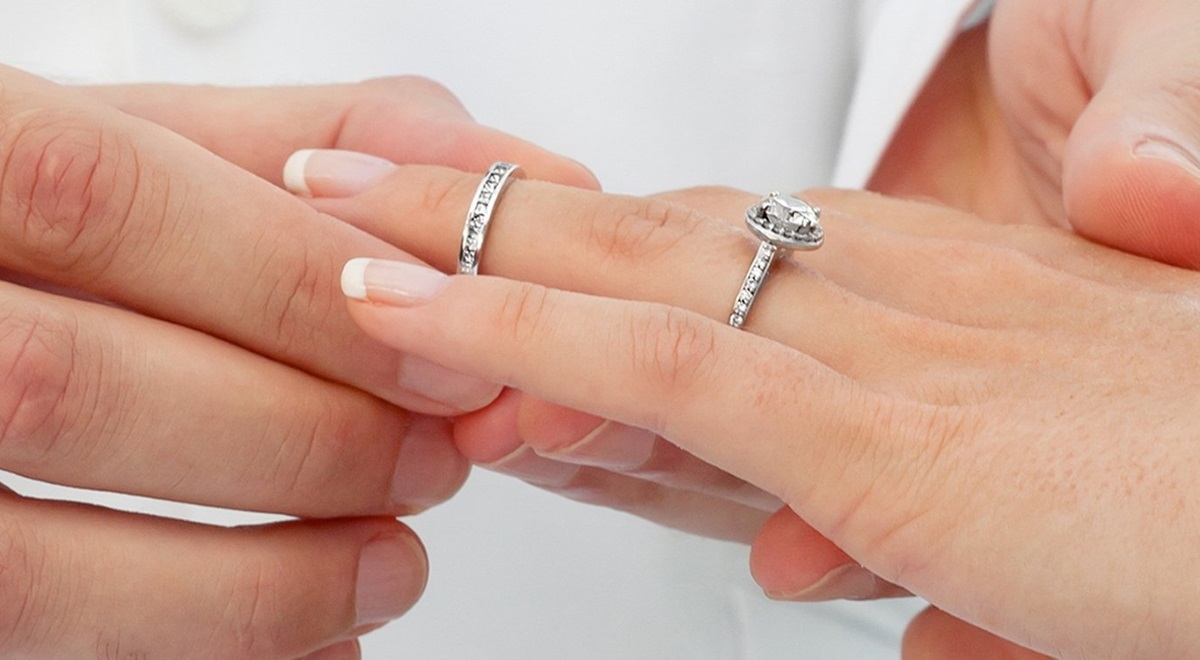 Кольцо помолвочное с бриллиантом на руке одевает мужчина